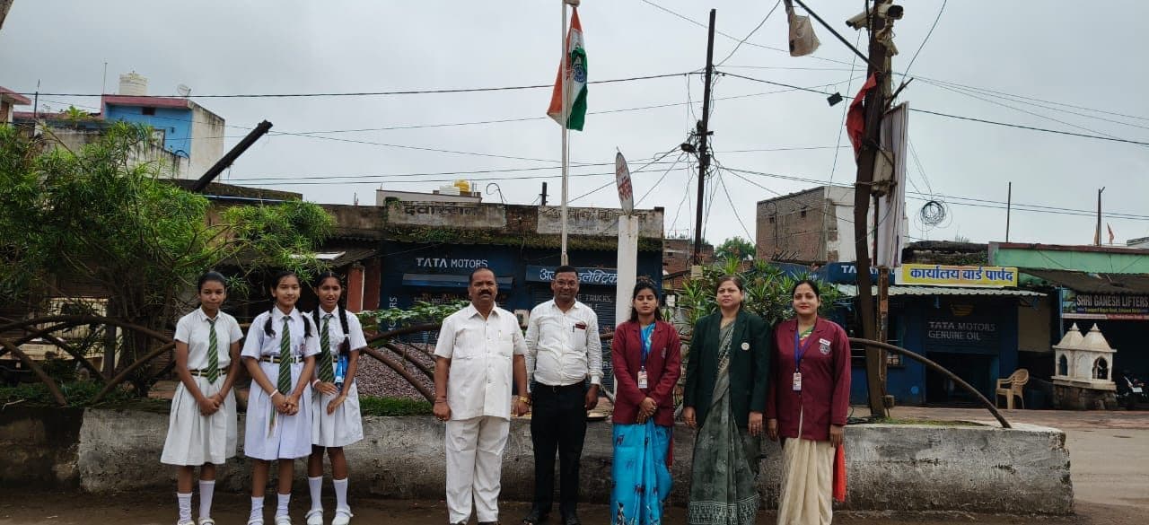 Students and staff standing at the flagpole for the national flag hoisting ceremony